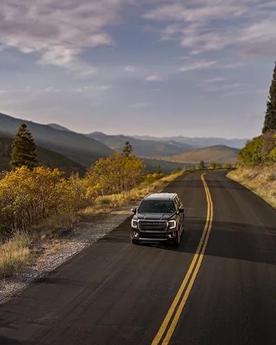 Snow Country vehicle travels through the canyon in autumn