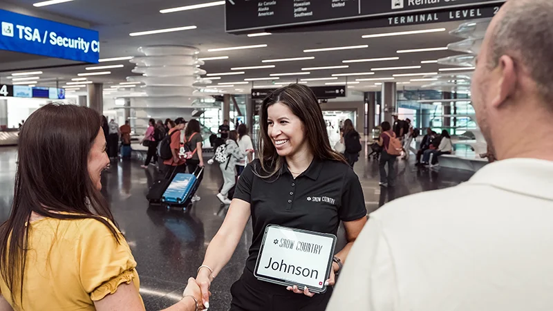 A Snow Country driver meets her customers at the airport