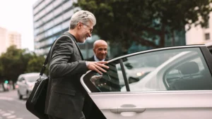 happy business man entering a car