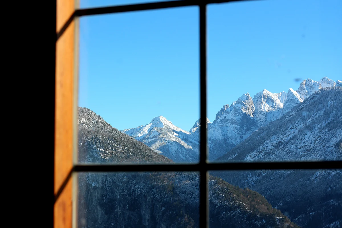 mountain view through a window from inside a lodge