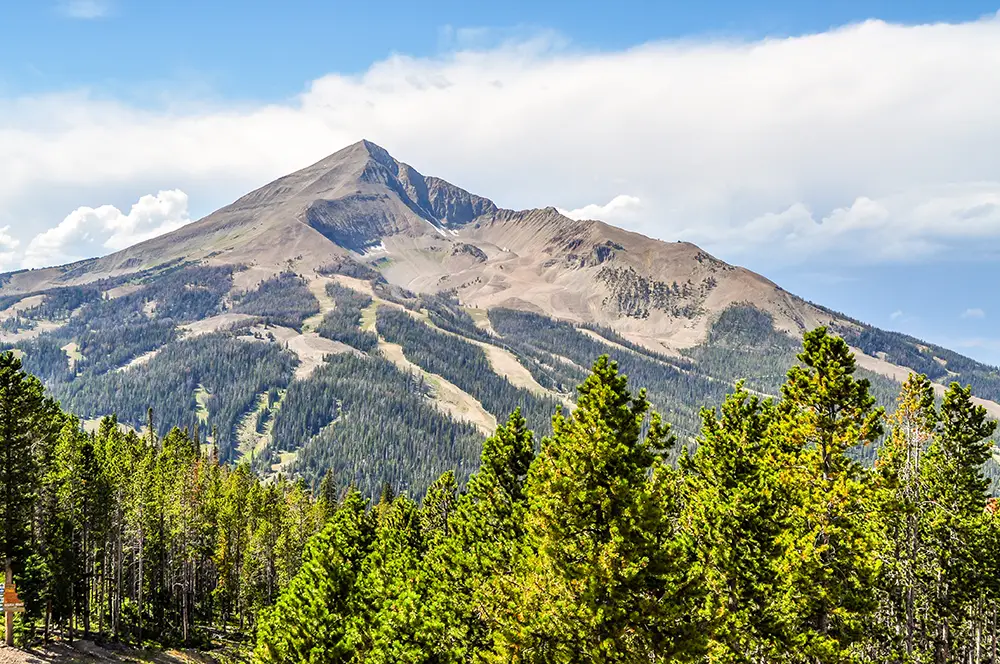 Big Sky summer activities 2026 can revolve around Lone Peak, pictured here with green trees in the foreground
