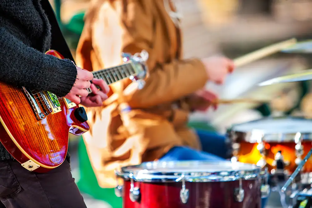 Festival music band. Hands playing on percussion instruments in park .